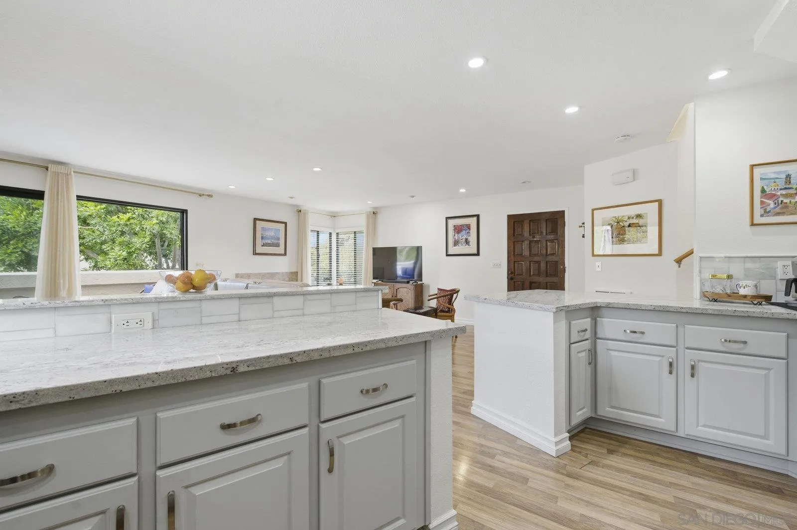 2742 Ariane Drive, Unit 153 San Diego, CA 92117 - Photo 15 of 43 a kitchen with granite countertop white cabinets and white stainless steel appliances