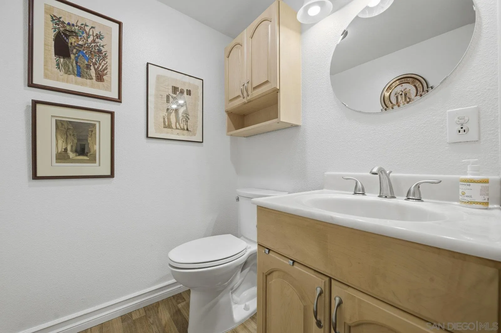 2742 Ariane Drive, Unit 153 San Diego, CA 92117 - Photo 19 of 43 a bathroom with a toilet a sink and mirror