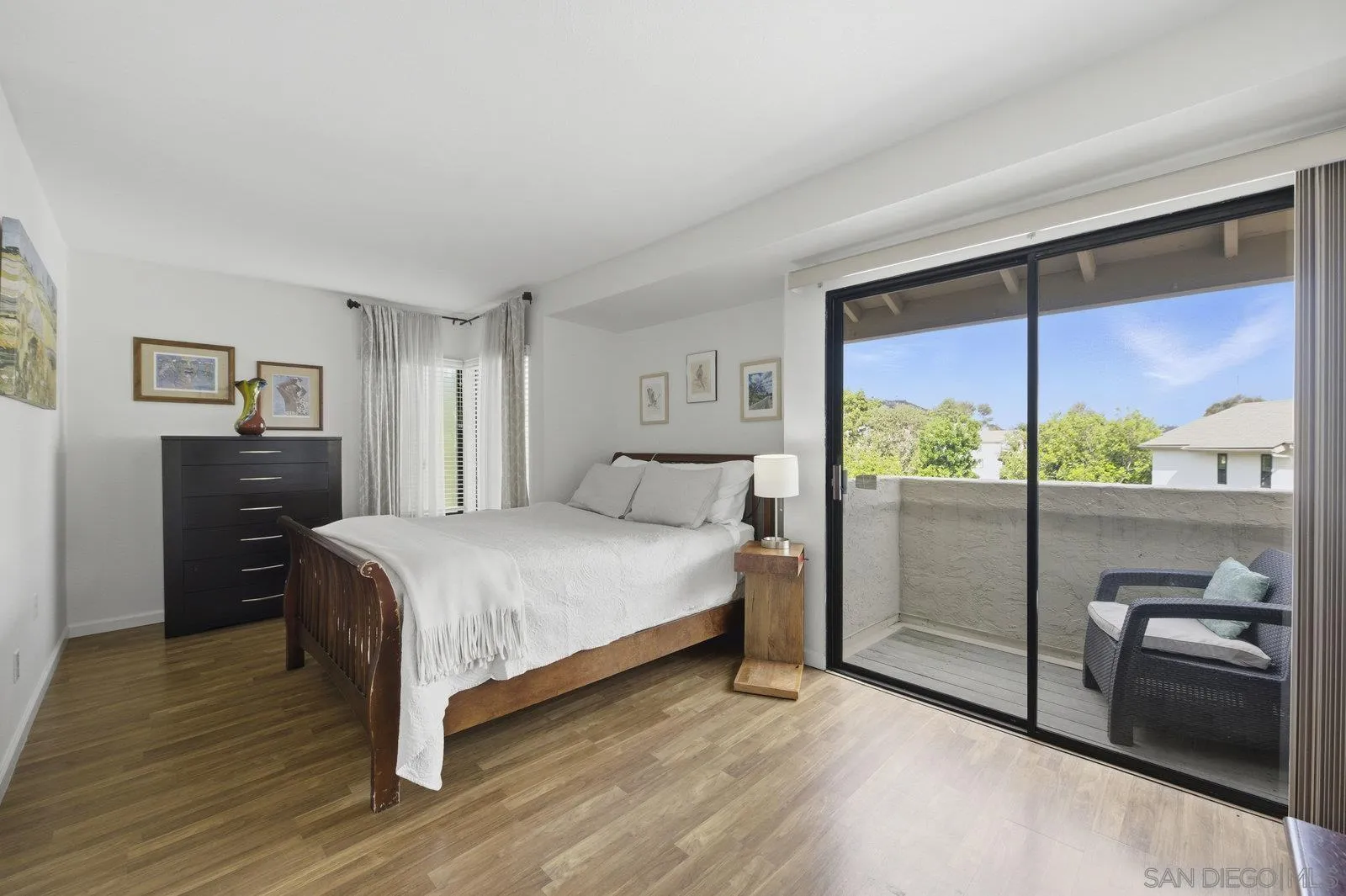 2742 Ariane Drive, Unit 153 San Diego, CA 92117 - Photo 27 of 43 a bedroom with a bed and large glass window