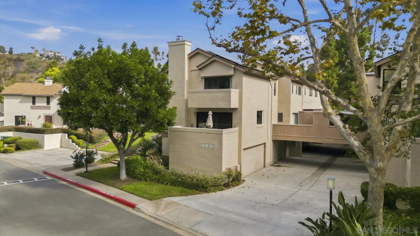 2742 Ariane Drive, Unit 153 San Diego, CA 92117 - Photo 4 of 43 a front view of a house with a yard