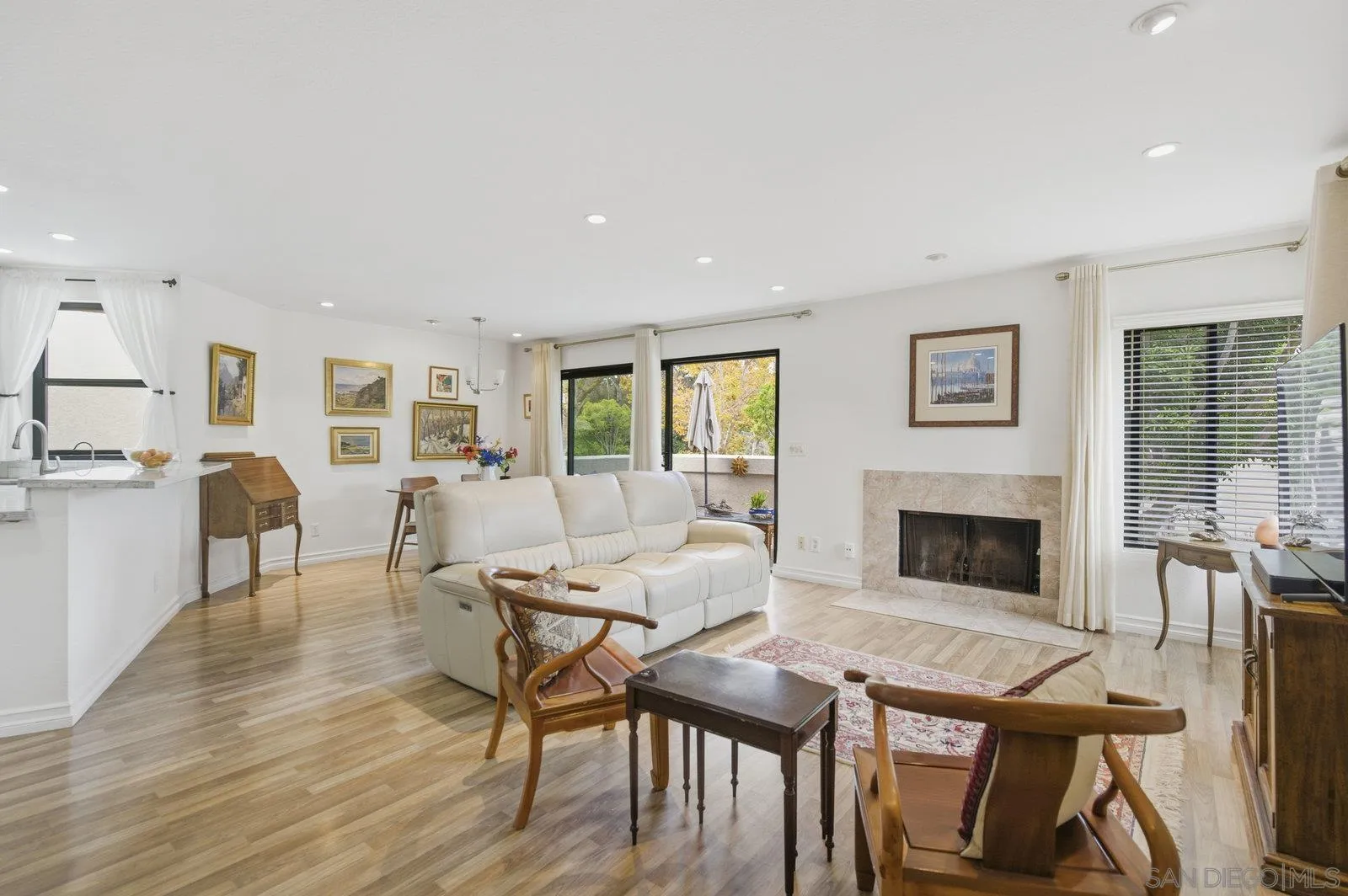 2742 Ariane Drive, Unit 153 San Diego, CA 92117 - Photo 8 of 43 a living room with furniture a fireplace and a table