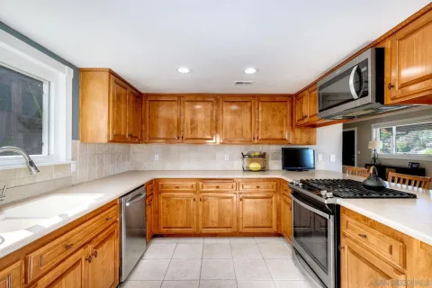 a kitchen with a sink appliances and cabinets