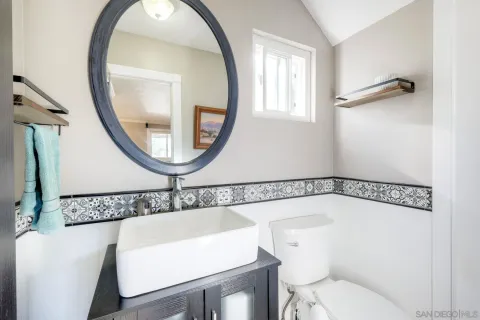 a bathroom with a toilet a sink and a mirror
