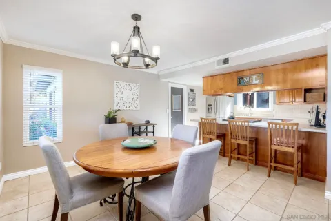 a view of a dining room with furniture and chandelier