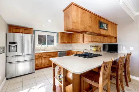 a kitchen with stainless steel appliances a stove a sink dishwasher and a refrigerator