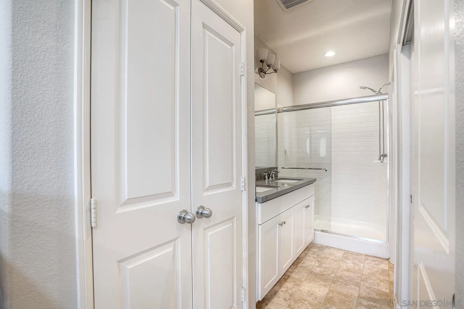 8850 Olive Lane, Unit 7 Santee, CA 92071 - Photo 17 of 27 a bathroom with a granite countertop sink a vanity and a mirror