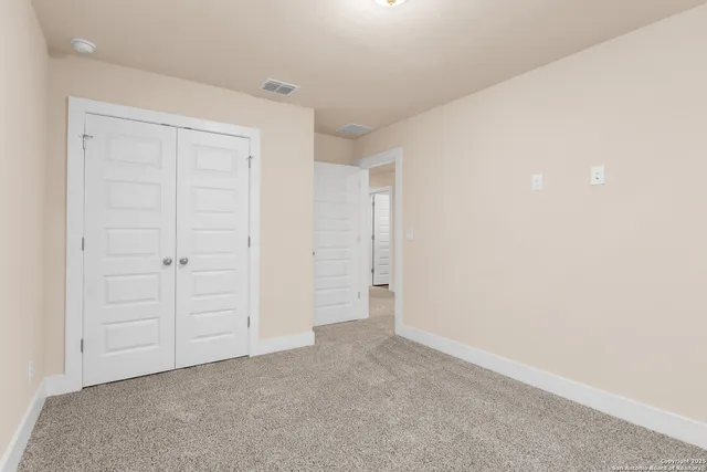 an empty room with closet area