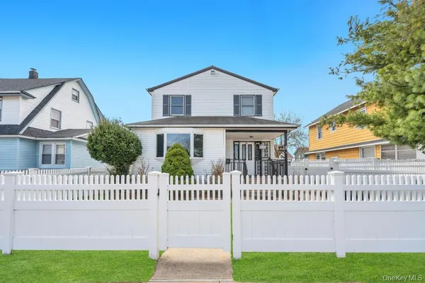 a view of a house with a yard and a garden
