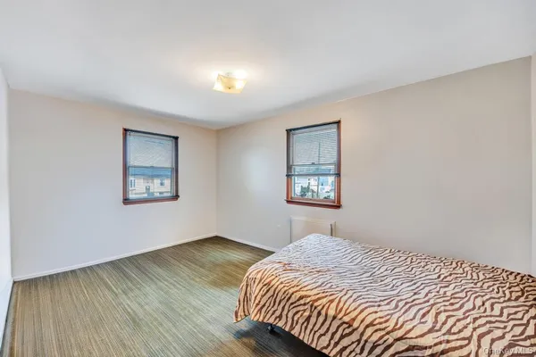 a bedroom with bed and window