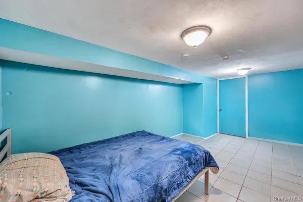 a bedroom with a bed and a potted plant