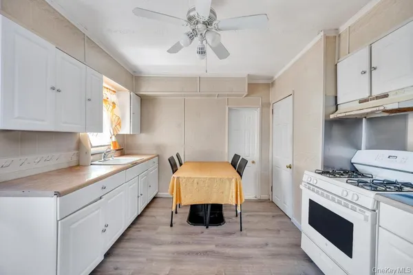 a kitchen with granite countertop a sink stainless steel appliances and cabinets