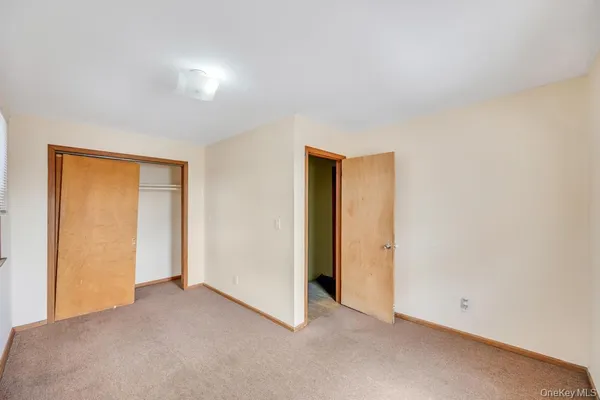 an empty room with closet area