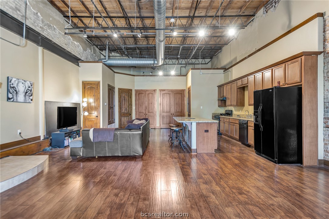 211 North Main Street, Unit 21 Bryan, TX 77803 - Photo 9 of 11 a large kitchen with lots of counter space and stainless steel appliances