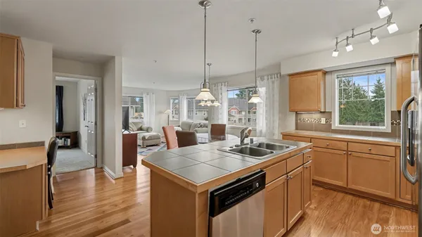 a kitchen that has a stove a table and chairs in it