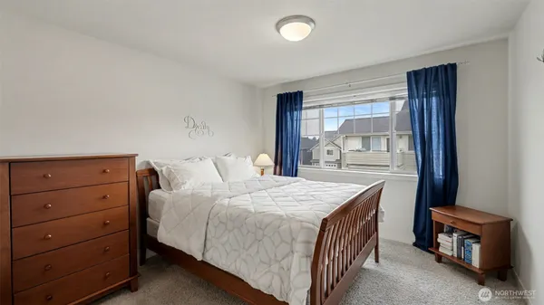 a bedroom with a bed and a dresser