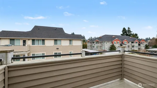 a large kitchen with stainless steel appliances granite countertop a sink a stove and a refrigerator