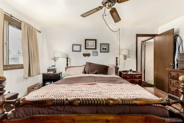 a bedroom with a large bed and a flat tv screen