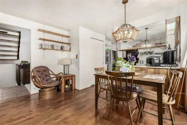 a view of a dining room with furniture wooden floor and chandelier