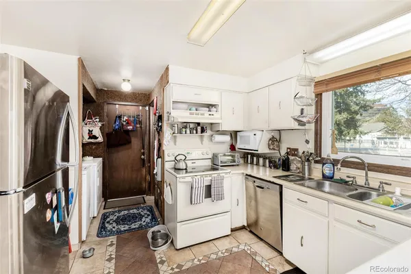 a kitchen with a sink stove and refrigerator
