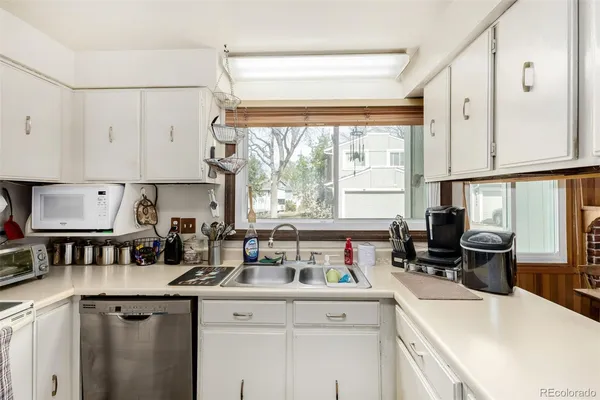 a kitchen with a sink stove and cabinets