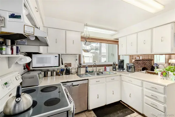 a kitchen with a sink stove and cabinets