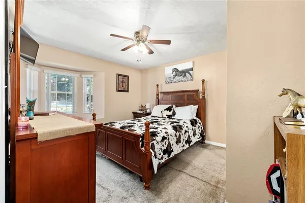 a bathroom with a granite countertop sink toilet and mirror