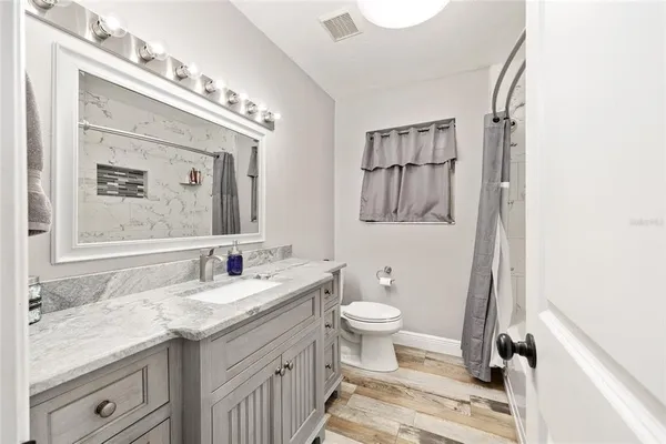 a bathroom with a toilet and a bathtub