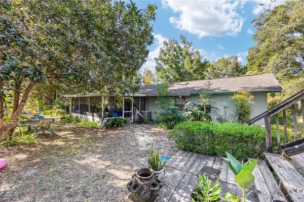 a view of a house with pool and sitting area