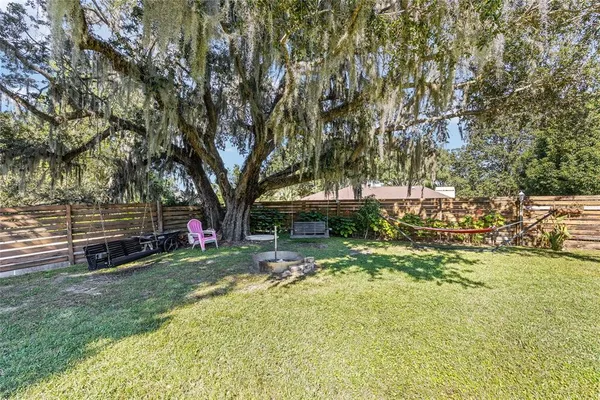 a view of a patio with a table chairs and a yard