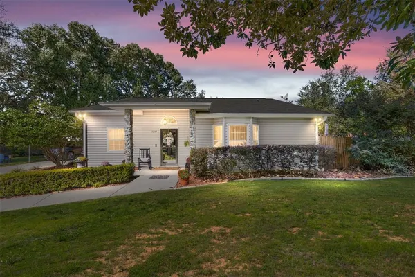 an aerial view of a house with a yard and trees