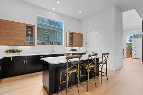 a kitchen with a table chairs sink and cabinets