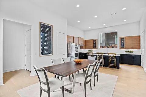 a large kitchen with a table and chairs