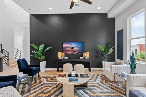 a view of a livingroom with furniture and a potted plant