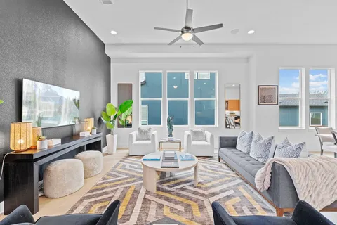 a living room with furniture and a large window