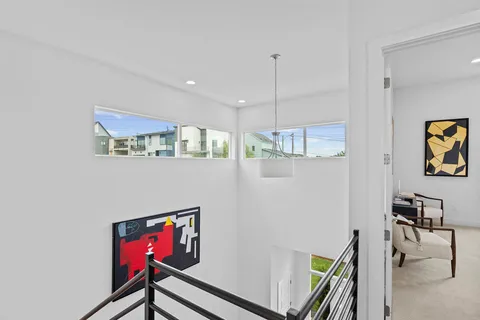 a view of a hallway with workspace and a window