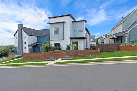 a view of brick house with a yard