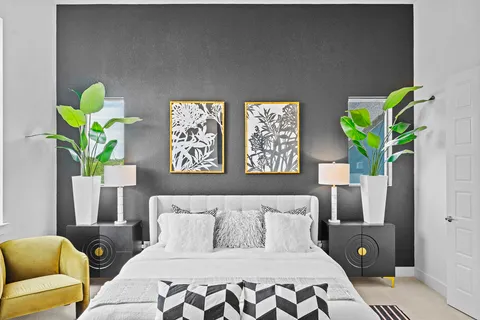 a bedroom with a bed table and a lamp