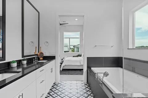 a bathroom with a bathtub sink and window