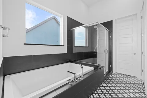 a bathroom with a bathtub and a shower