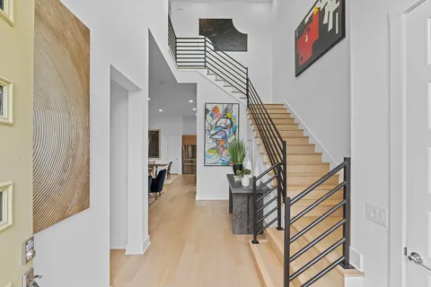 a view of entryway and hall with wooden floor