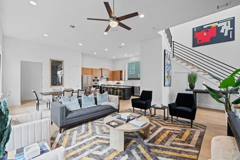 a living room with furniture and wooden floor