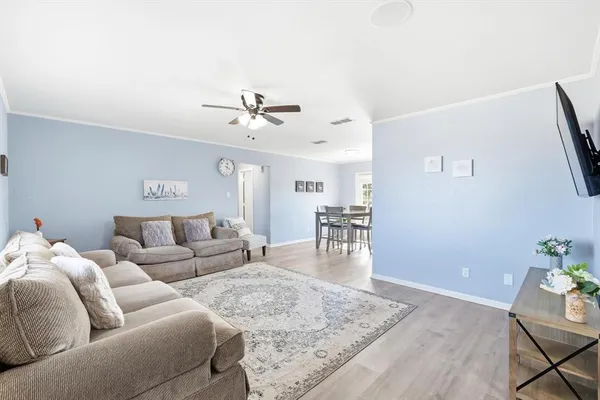 a living room with furniture and wooden floor