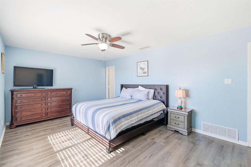 3873 Lois Road East Sanger, TX 76266 - Photo 22 of 40 a bedroom with a bed and a flat screen tv