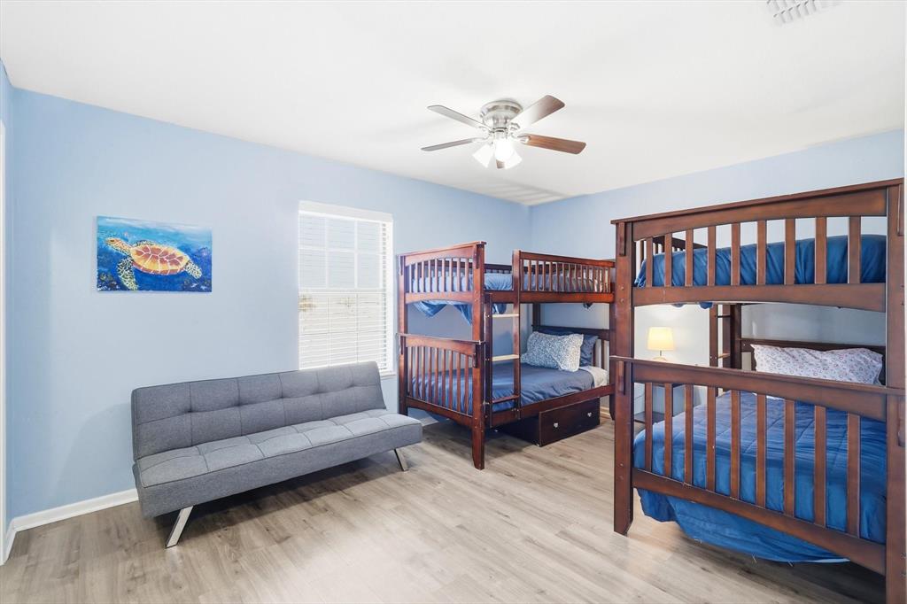 3873 Lois Road East Sanger, TX 76266 - Photo 25 of 40 a bedroom with furniture and a book shelf