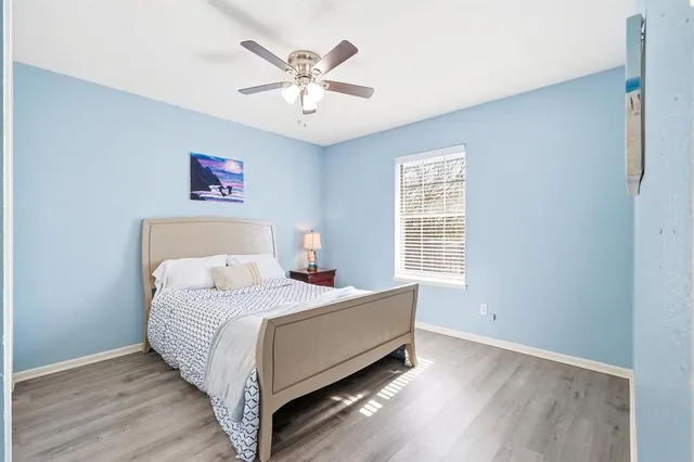a bed room with a bed and a chandelier