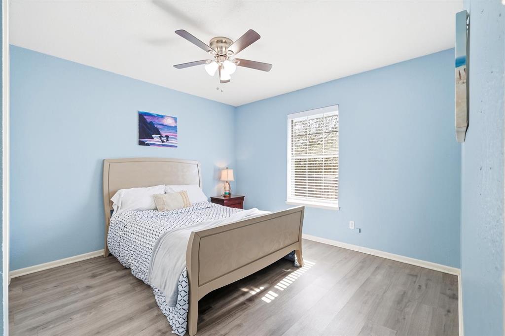 3873 Lois Road East Sanger, TX 76266 - Photo 27 of 40 a bed room with a bed and a chandelier