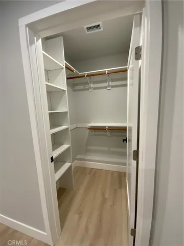 a view of walk in closet with empty racks