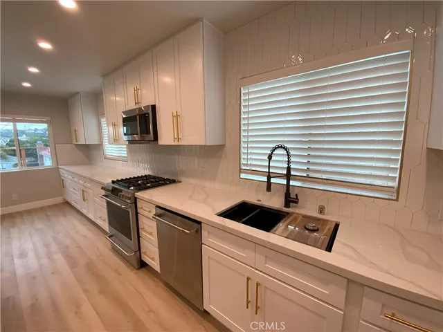 a kitchen with a stove and a refrigerator