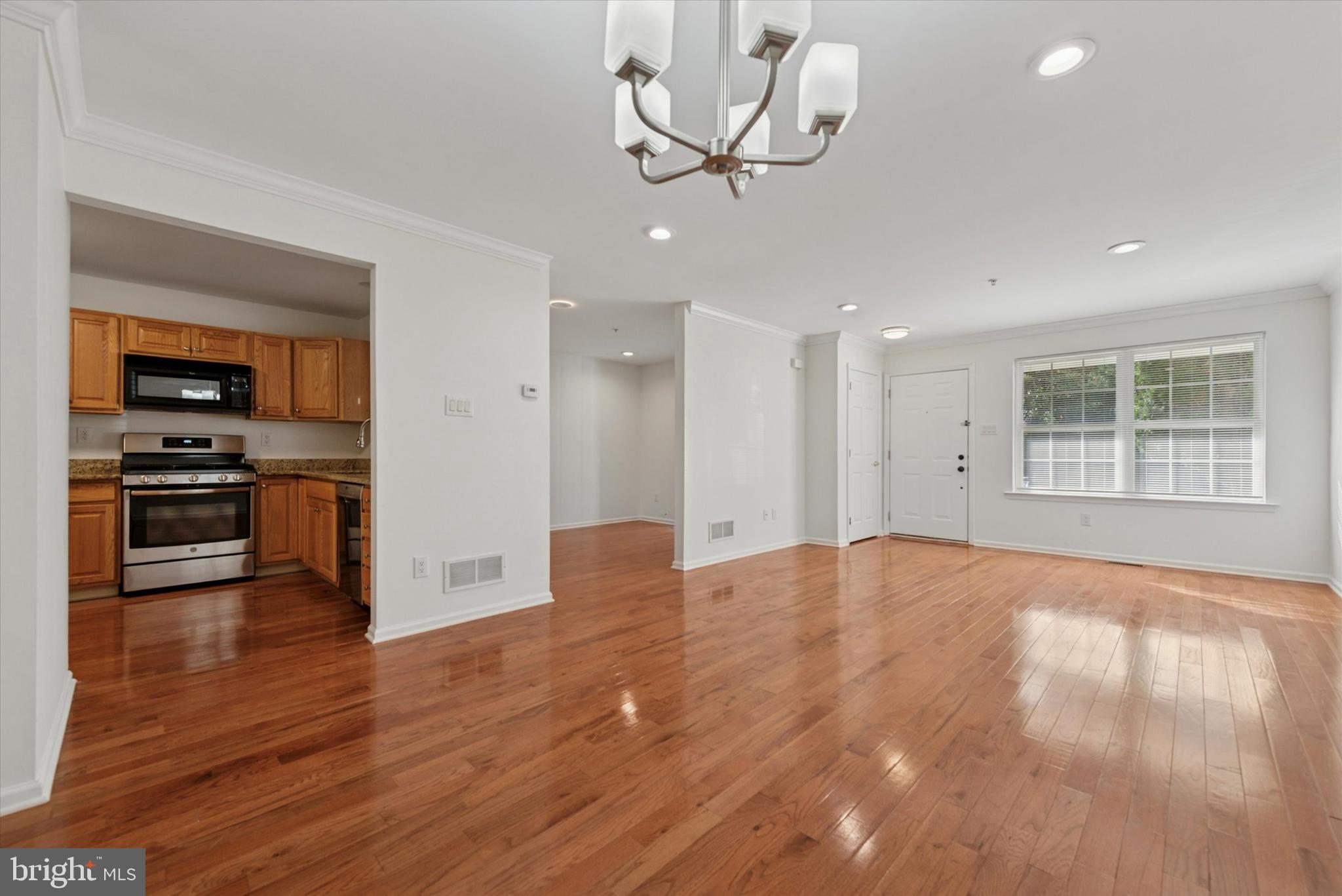 69 Granite Lane Chester Springs, PA 19425 - Photo 1 of 25 a view of empty room with wooden floor and kitchen view