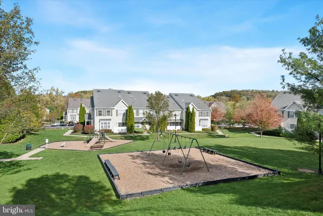 an aerial view of a house with a yard and trees
